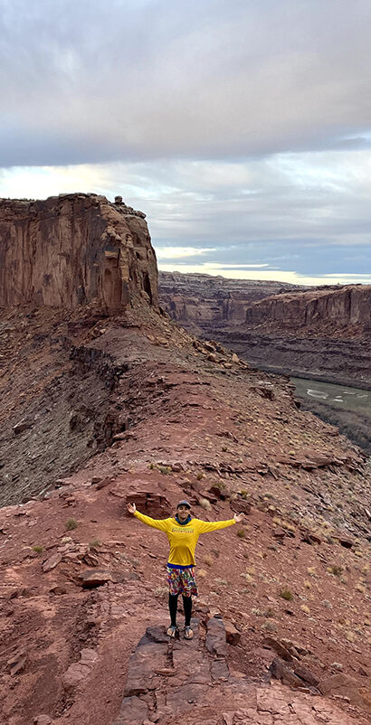 Student with arms out in Utah desert
