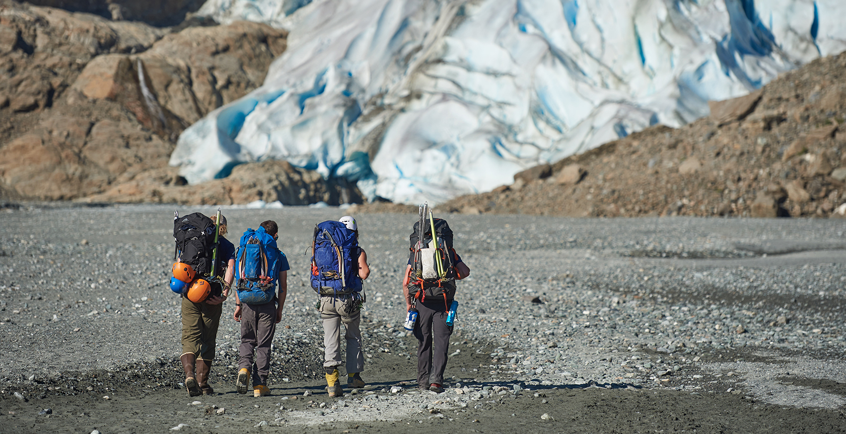 Group of kids hiking base of glacier