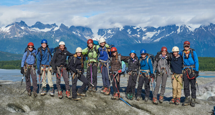 Traveler group photo all with rock climbing helmets and gear on
