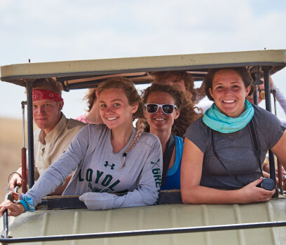 Travelers in a golf cart smiling