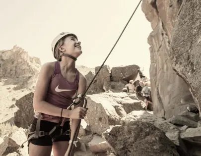 Traveler with rock climbing helmet, getting ready to climb