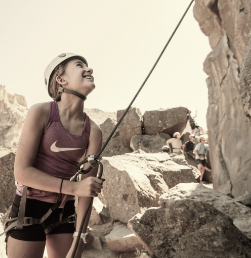 Traveler with rock climbing helmet, getting ready to climb