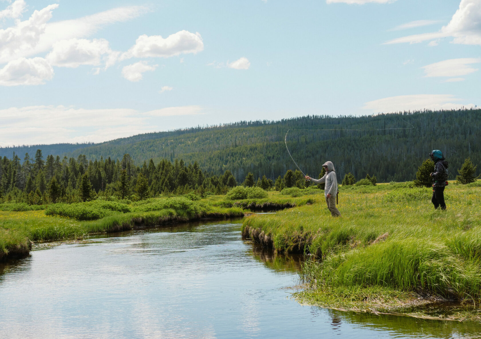 students fly fishing in remote river in Wyoming