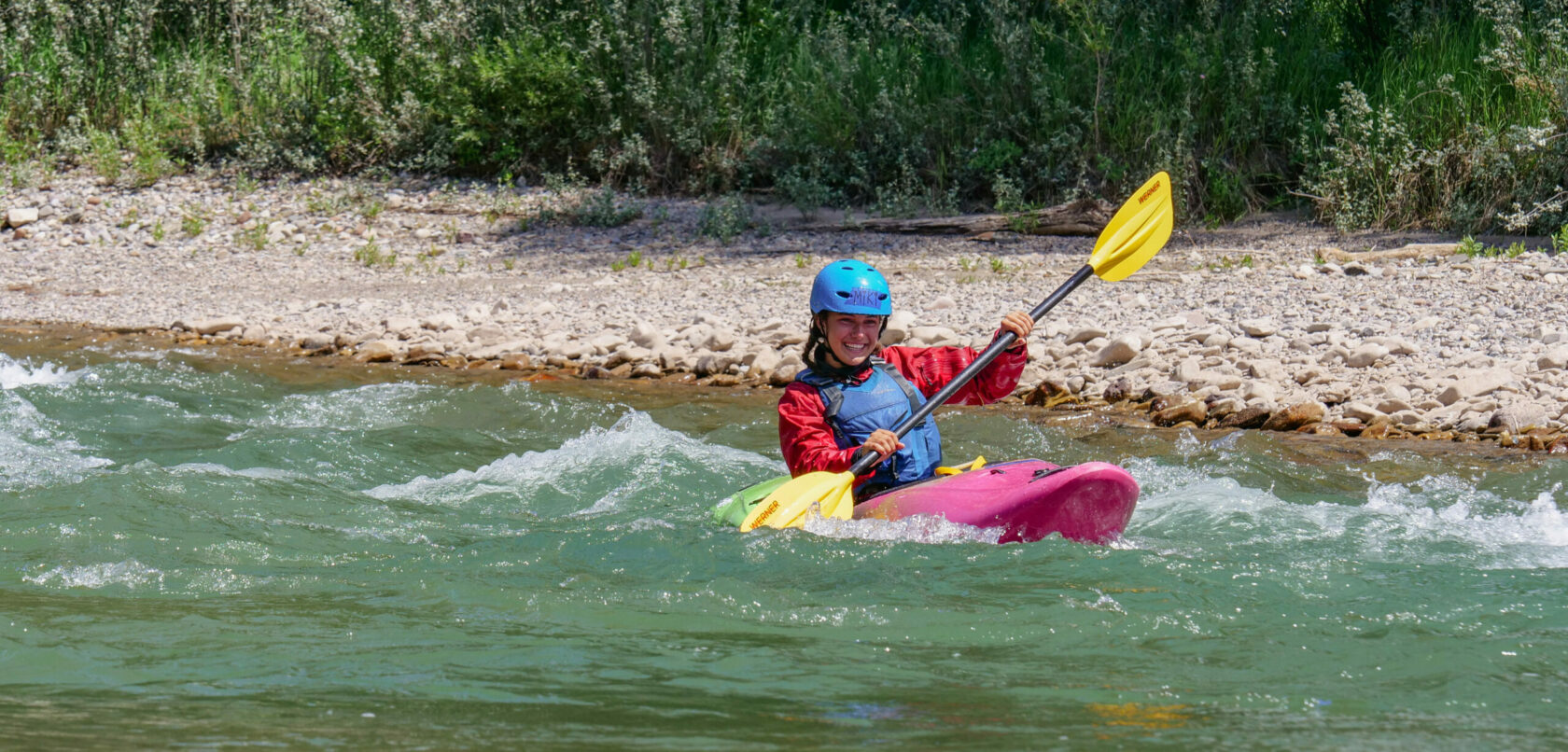 smiles while whitewater kayaking on the snake river