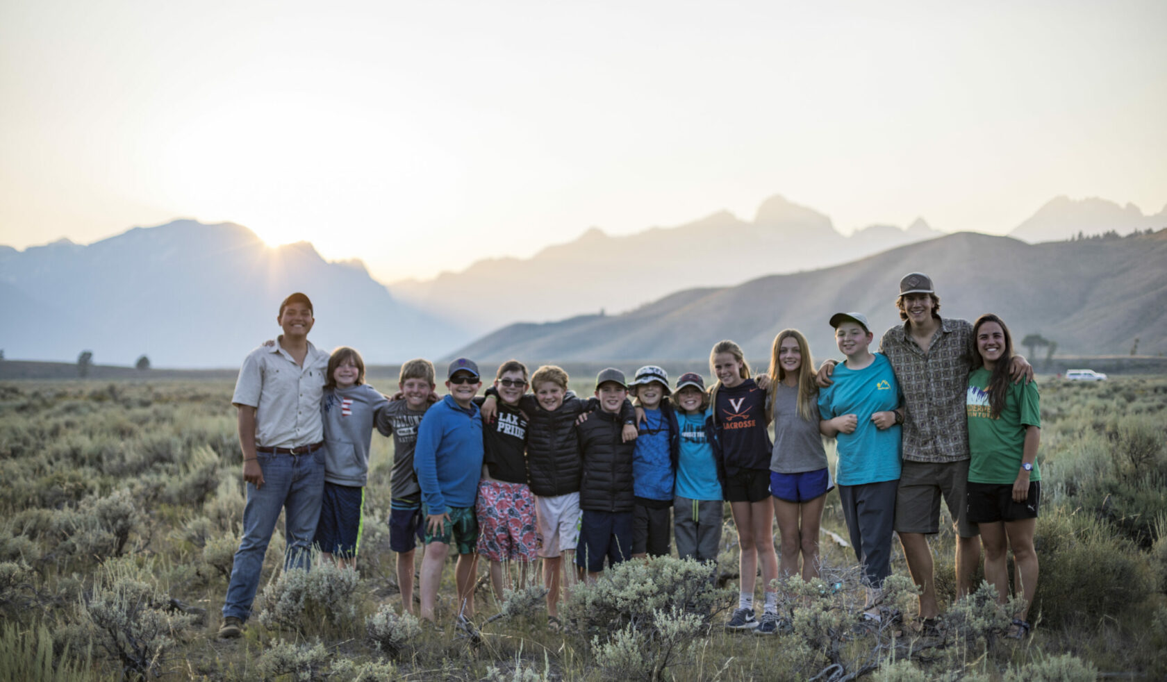 group in front of tetons at sunset