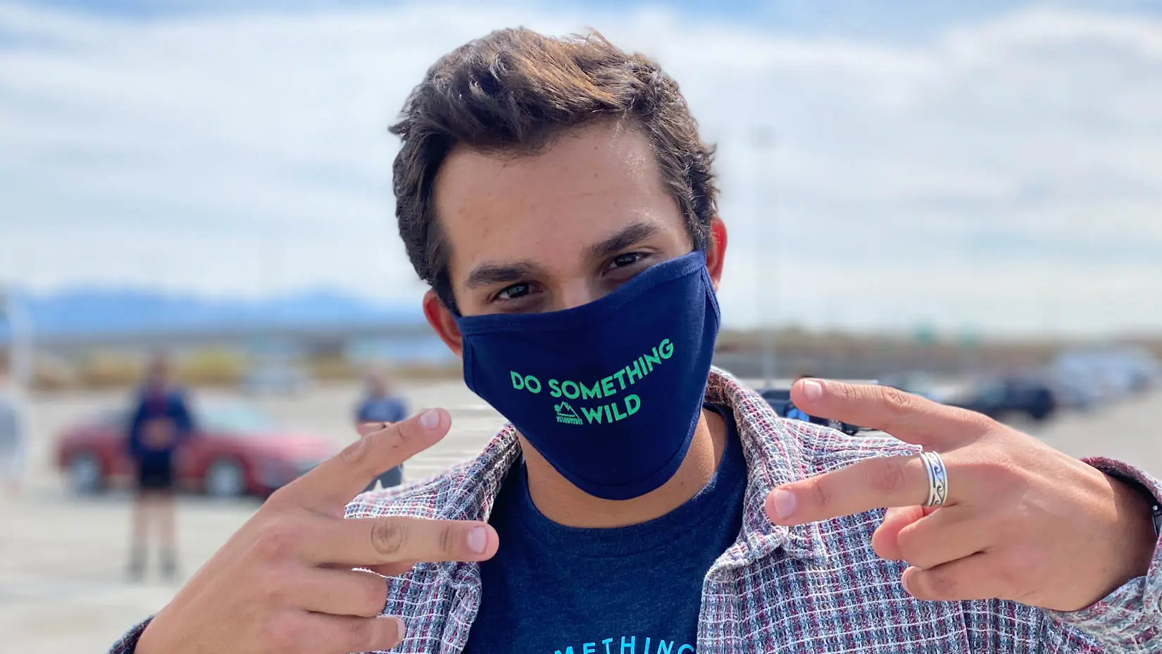 Traveler wearing a "Do Something Wild" mask