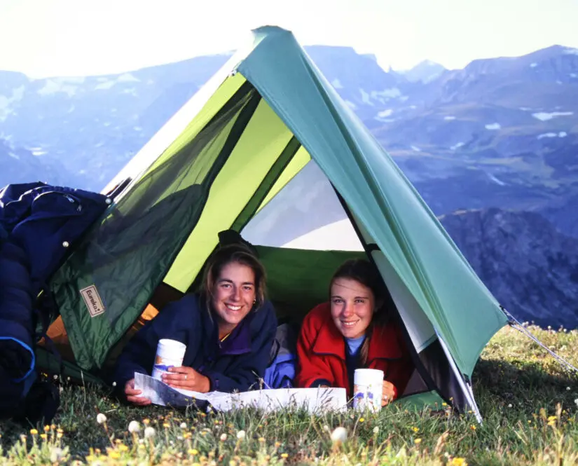 Two girls smiling in their tent