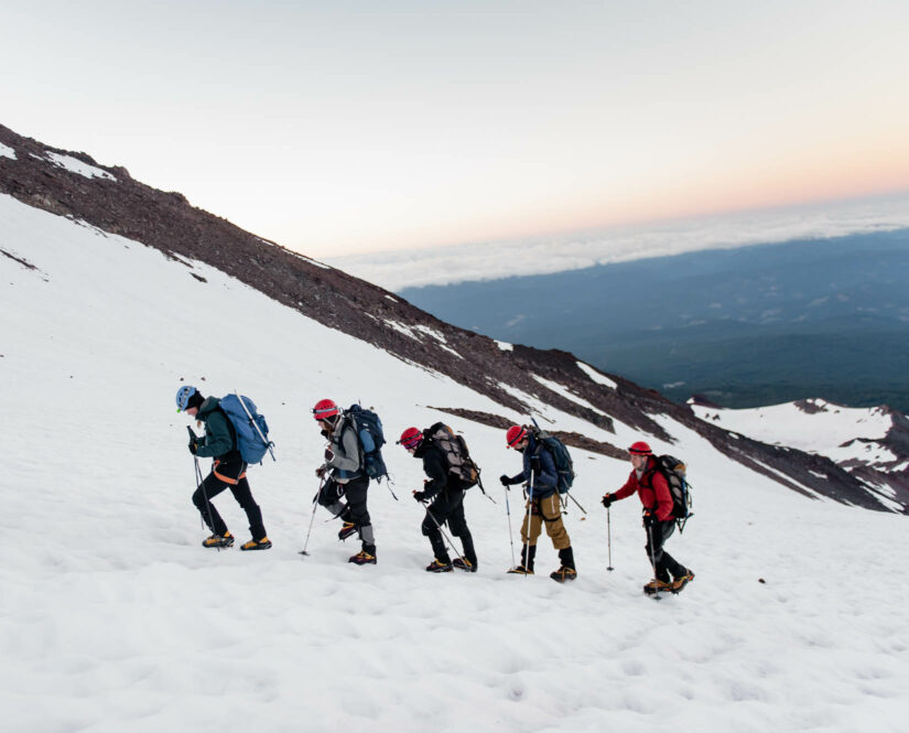 Travelers hiking up Mount Shasta in the snow
