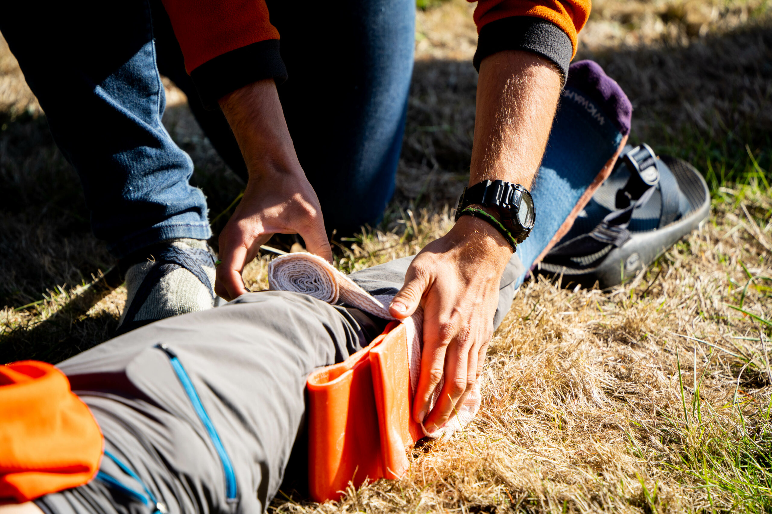 close of up a leg being put in a splint practicing wilderness medicine