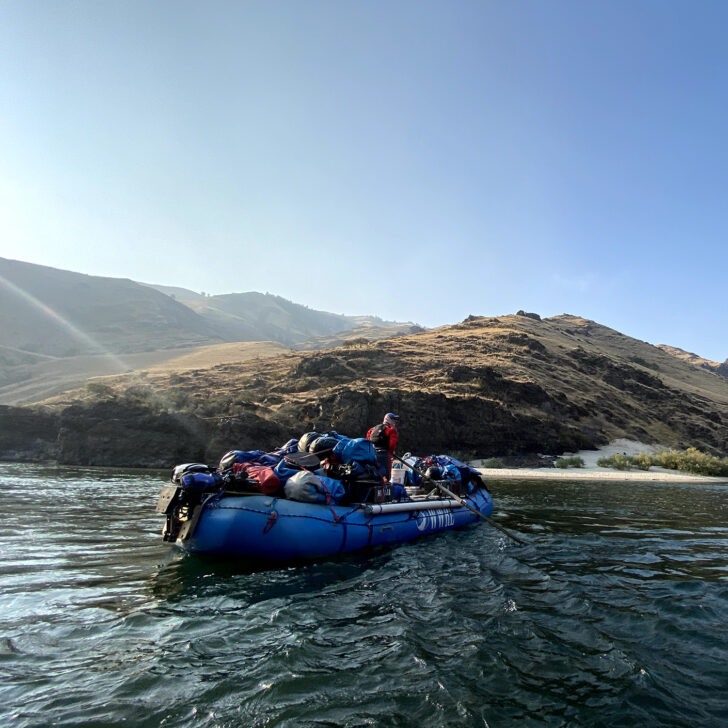 Whitewater rafting guide with loaded boat