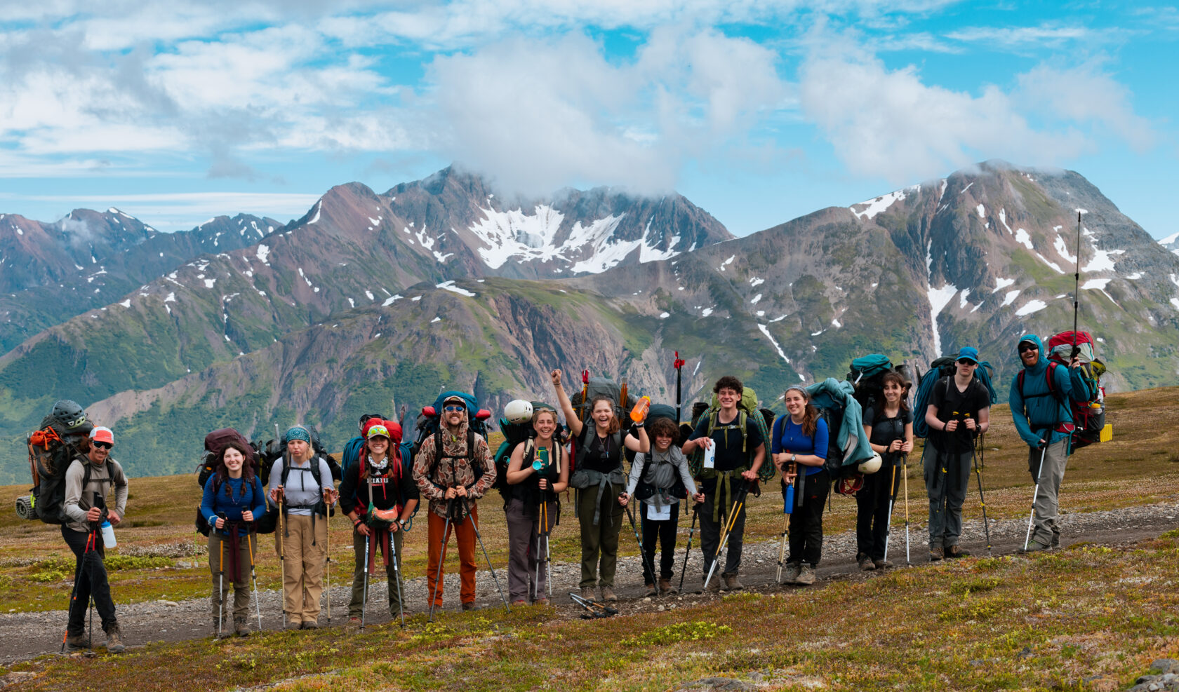 group of students posing for a picture while backpacking in alaska