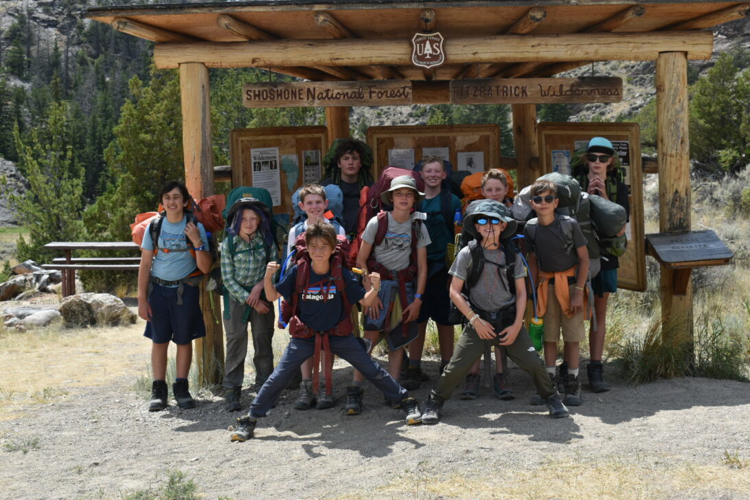 Group about to backpack, at the trailhead sign