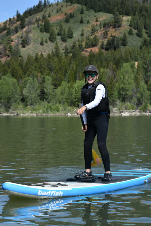 student stand up paddle boarding