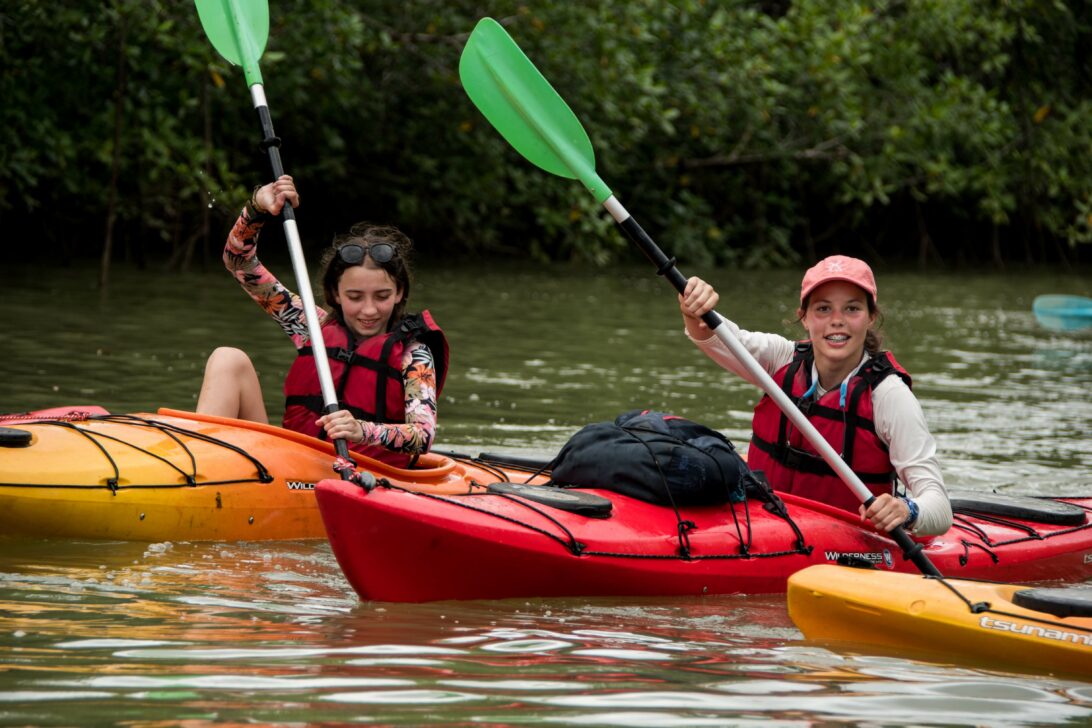 students sea kayaking