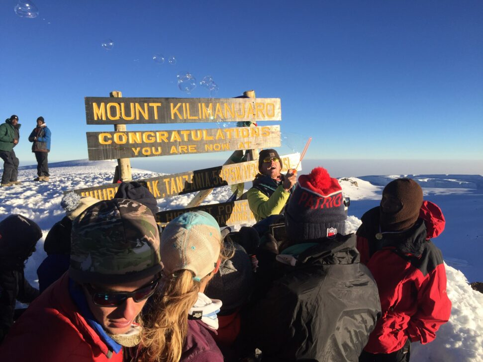 group blowing bubbles at the summit of Kilimanjaro