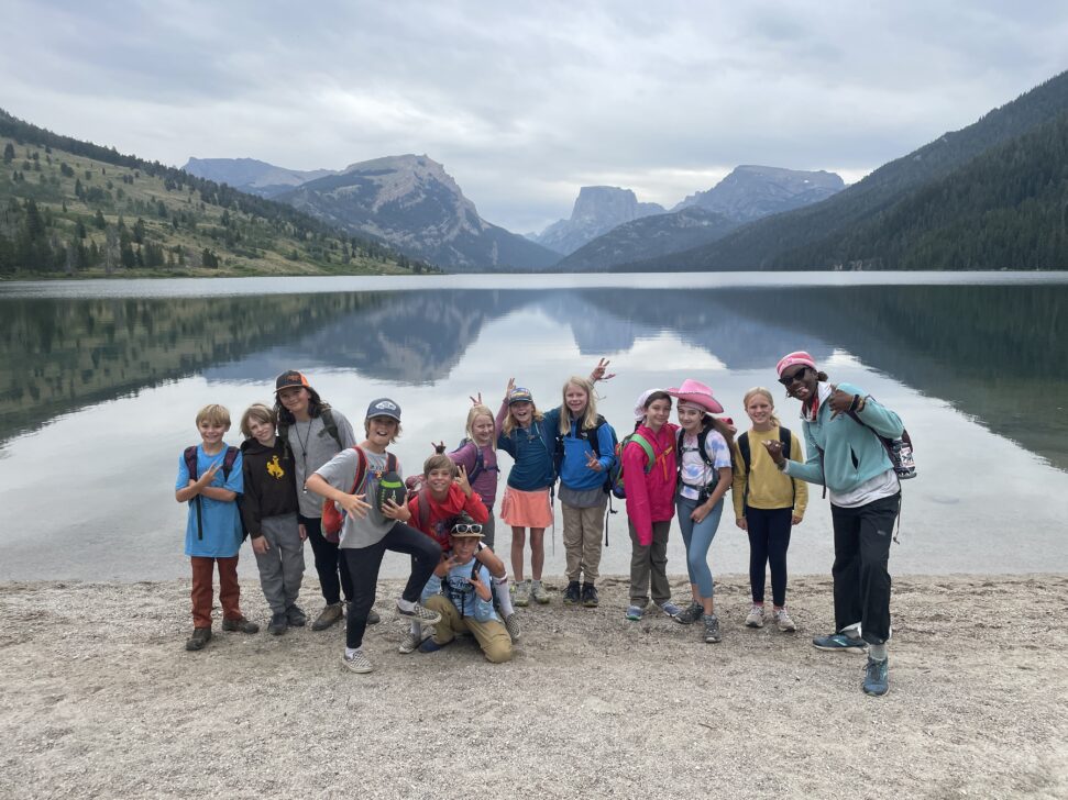 silly group photo in front of a lake in wyoming