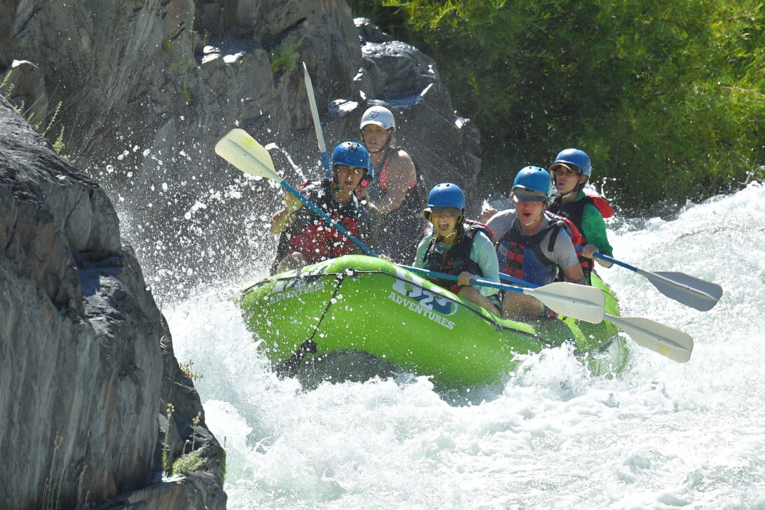 a raft goes through a rapid