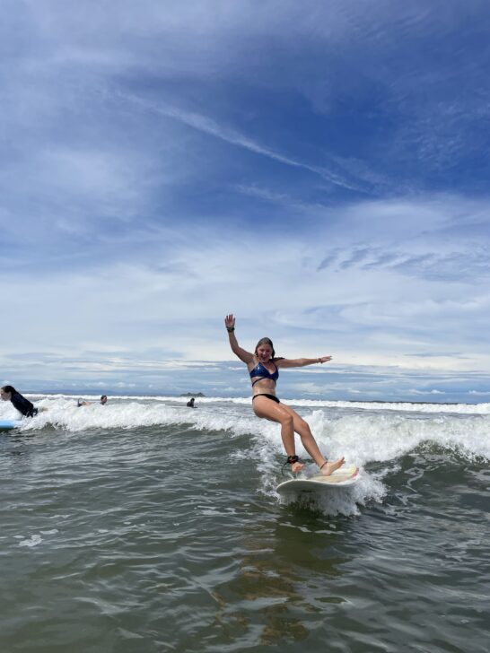 student falling off her surfboard