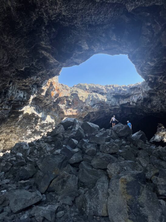 students in a cave at craters of the moon national monument