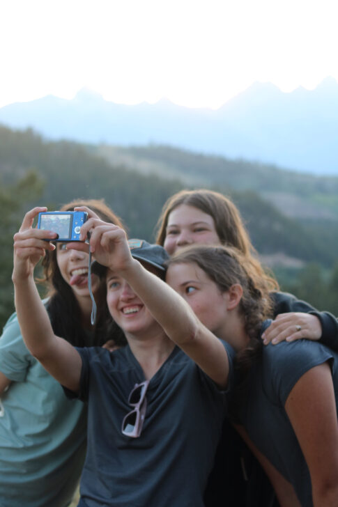 group of students taking a selfie on a camera in Grand Teton National Park