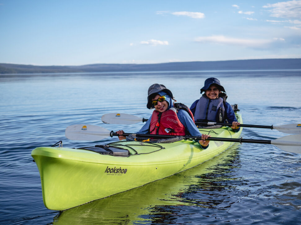 two students in a double sea kayak on yellowstone lake