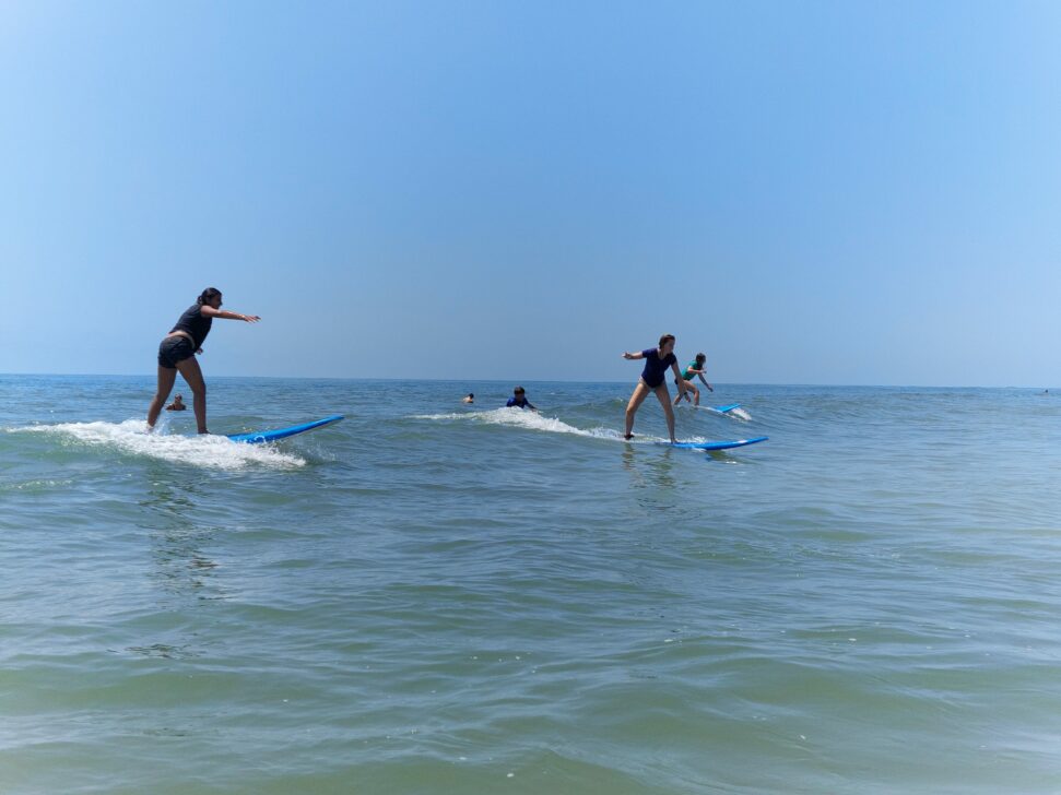 3 people surfing