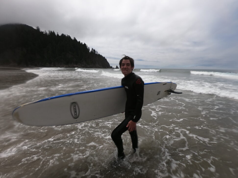 Boy holding surf board