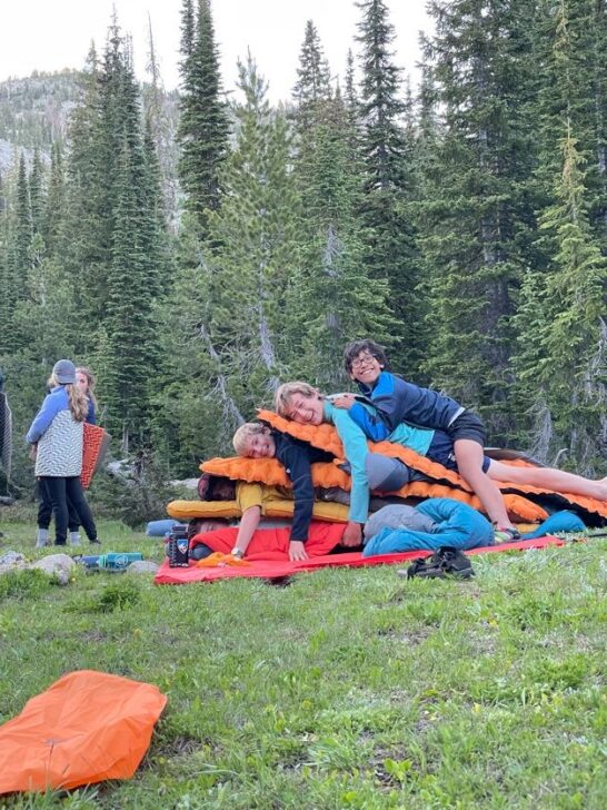 Group piled on top of each other with camping pads