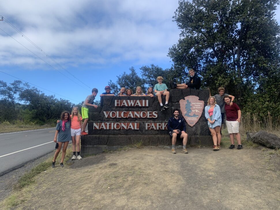 Group in front of Volcanoes National Park sign