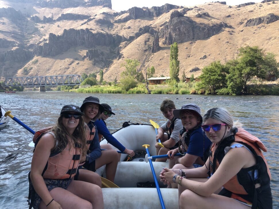 Group in a white water rafting boat