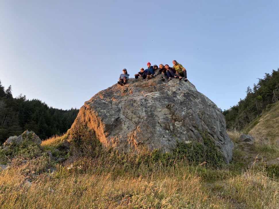 group of students on a big rock