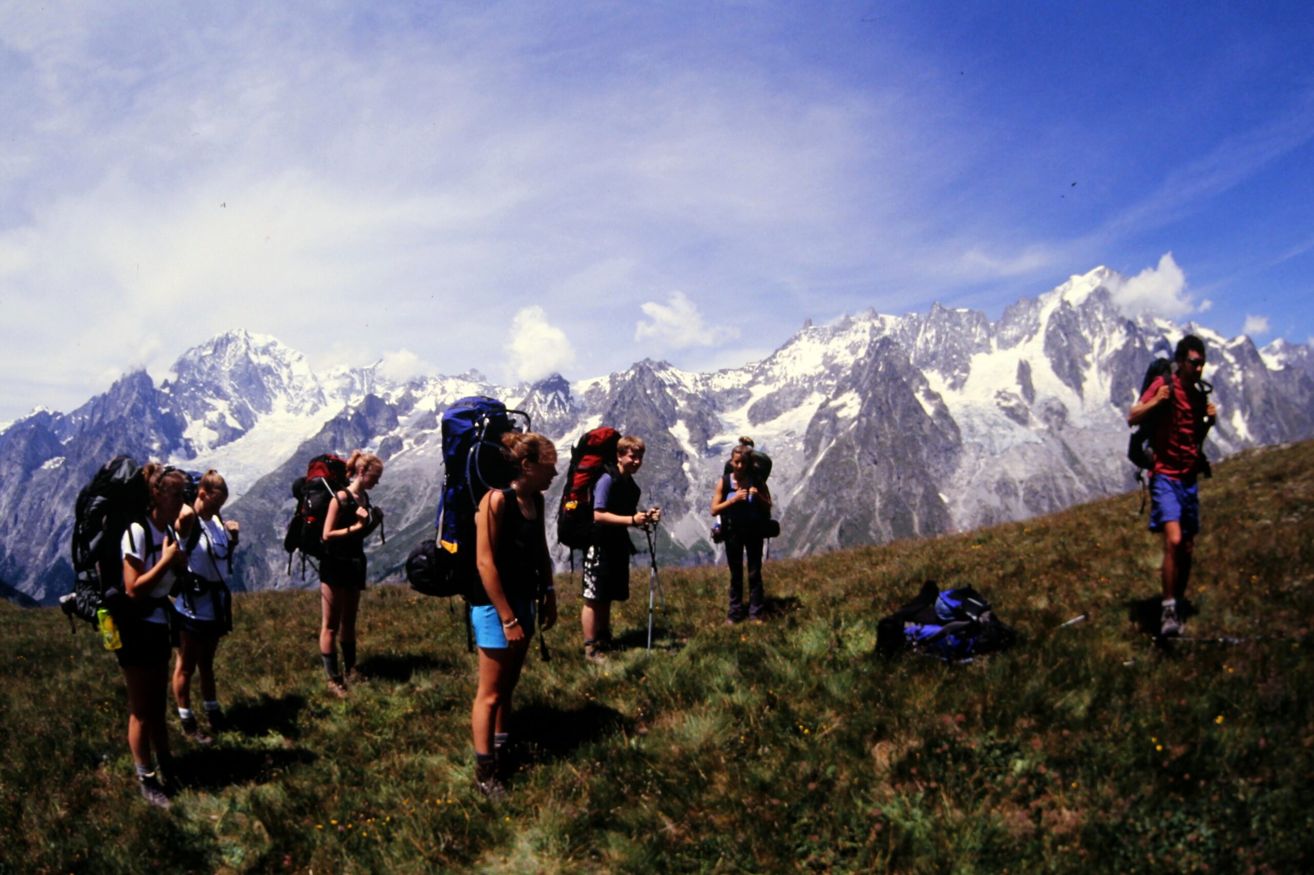 2002 backpacking in front of snowy mountains