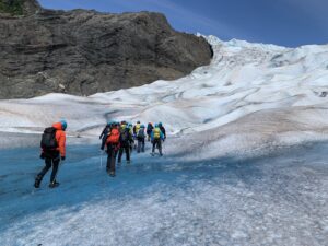 group walking on a glacier