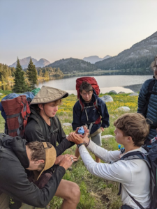 holding sports drink while backpacking