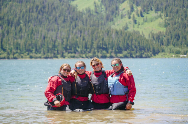 4 girls with lifejackets in a river