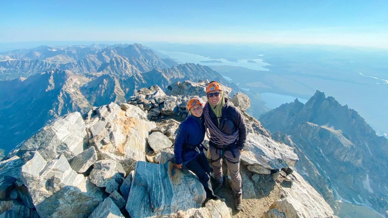 Two people on the summit of the Grant Teton.