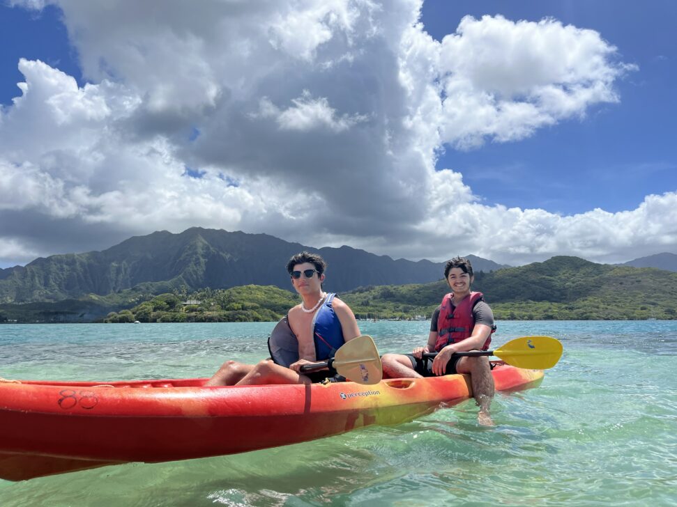 2 boys in a sea kayak in hawaii