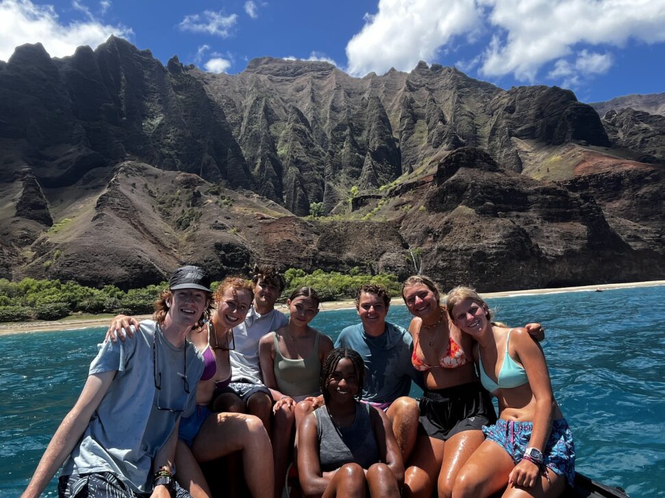 Group on a boat in front of the Na Pali Coast hawaii