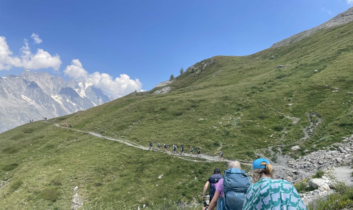Group backpacking through the alps