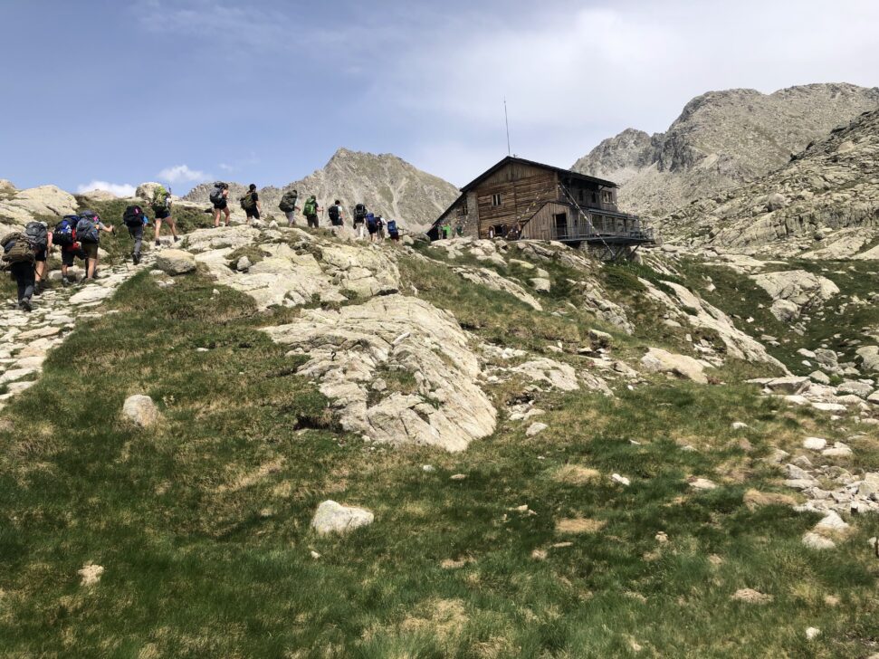 students hiking to a backpackers hut in the pyrenees