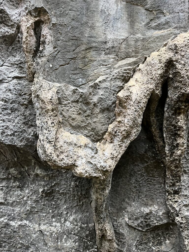 Close up of hand hold on a limestone rock climbing wall. 