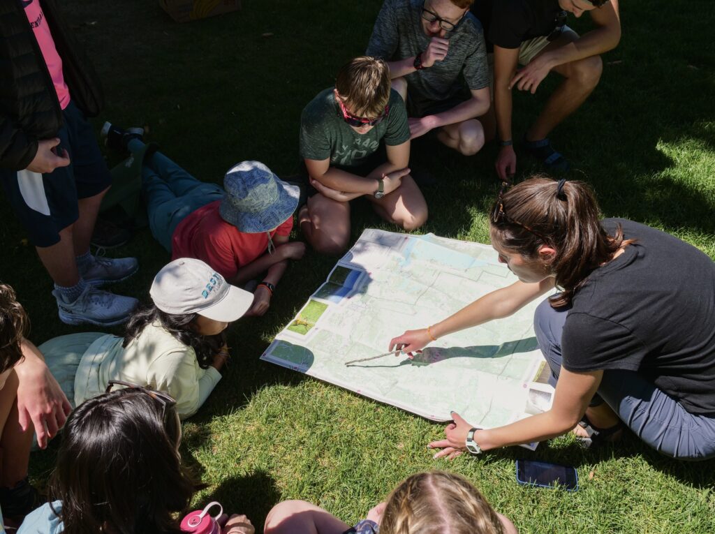 Female teaching students how to read a topographic map.