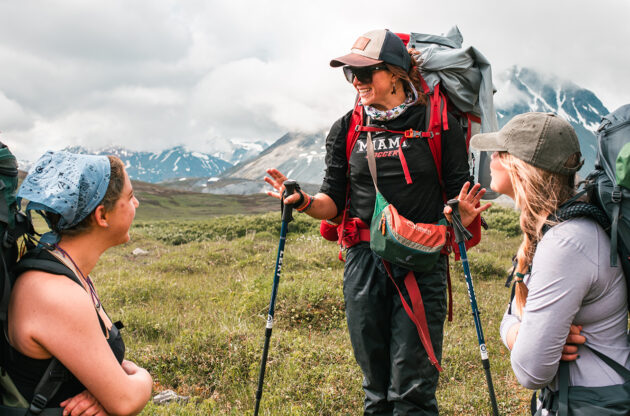 Woman talking to students while backpacking in Alaska