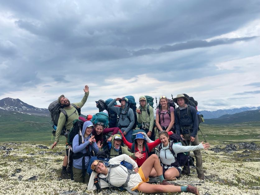 Group of backpackers doing silly poses. 