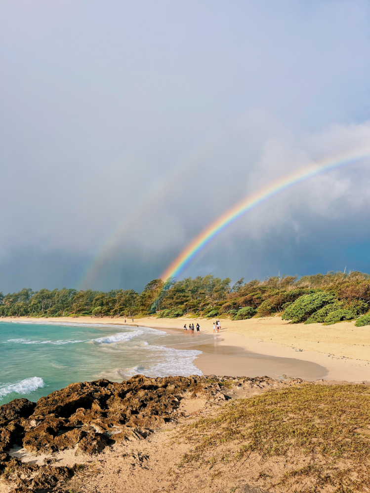 A double rainbow on a beach in Hawaii.