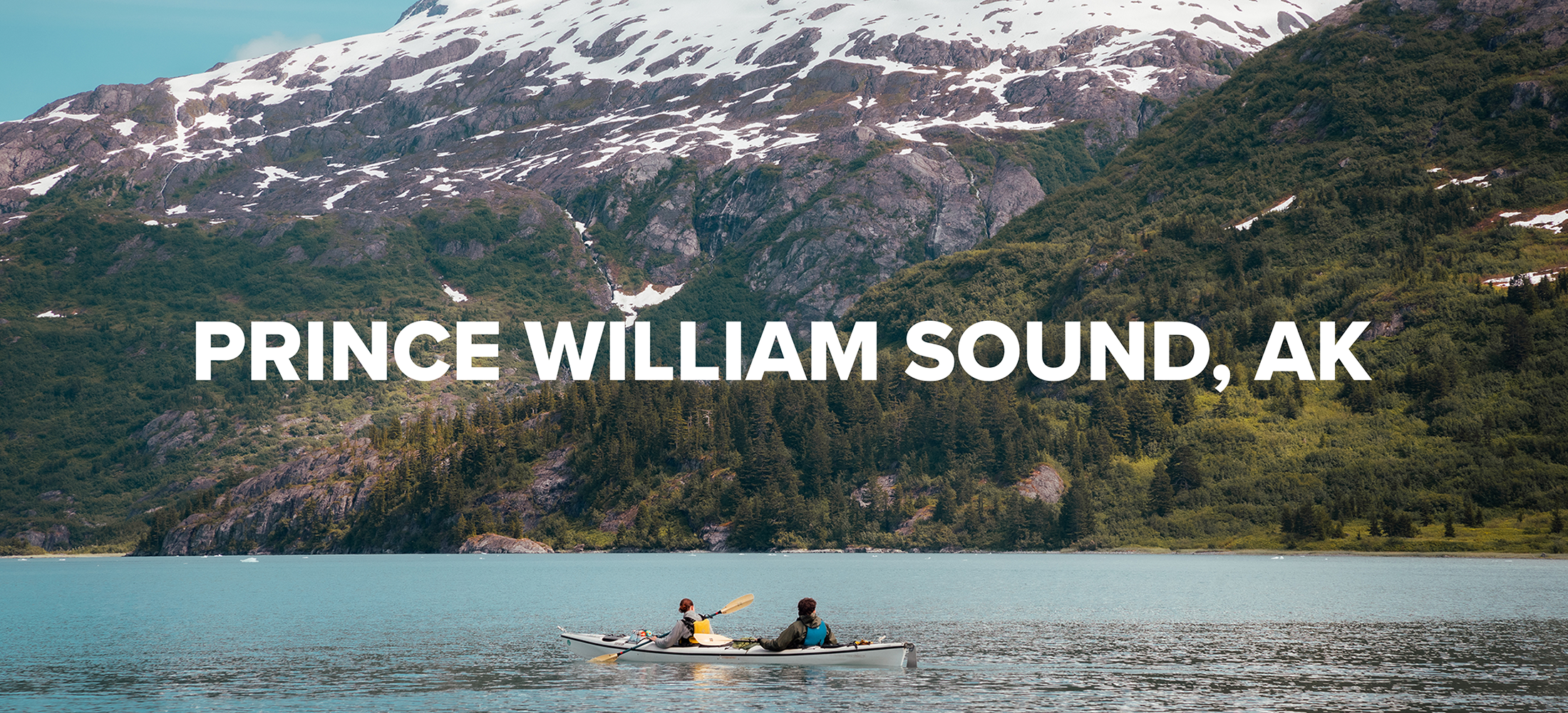 Two people sea kayaking in the Prince William Sound. 